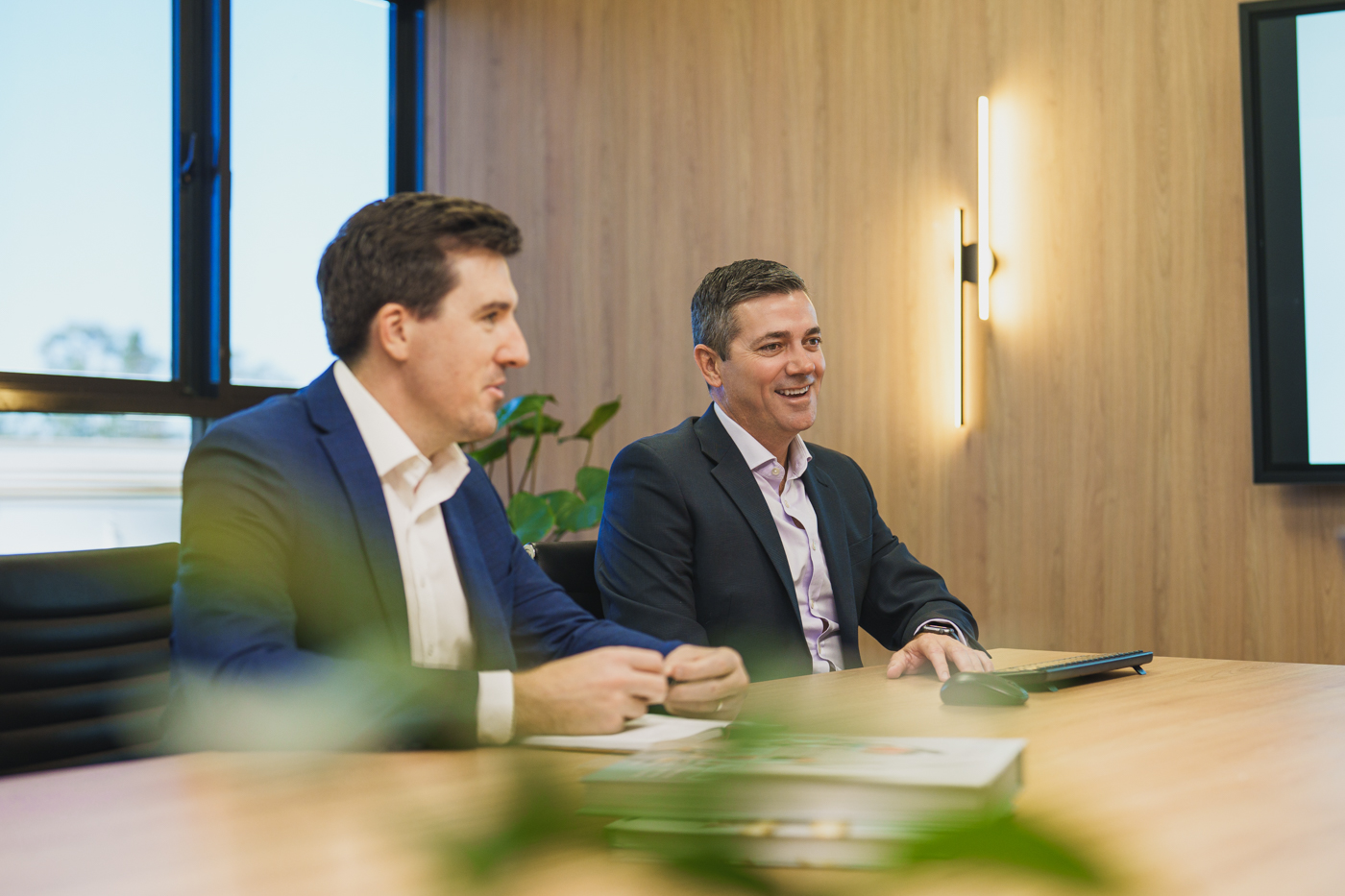 Shane and Matthew in a board room meeting amd